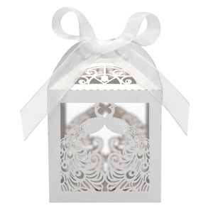 Detail view of white peacock laser cut wedding favor box with elegant satin ribbon bow
