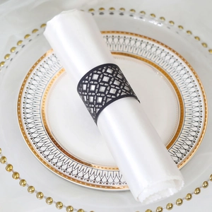 Detailed view of black laser-cut geometric napkin ring on a white elegant dinner napkin