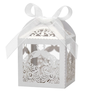 Laser-cut wedding favor box with peacock pattern and white satin ribbon bow detail