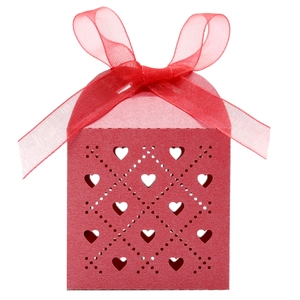 Detail of red laser cut heart gift box with pearl paper texture and organza ribbon bow