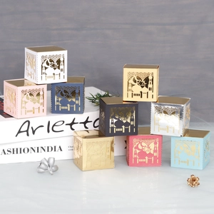 Close-up of laser-cut moon and palace patterns on colorful decorative candy gift boxes