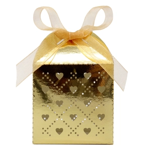 Detail of golden laser-cut heart candy box with glossy finish and organza ribbon
