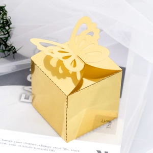 Close-up of golden mirror gift box featuring a delicate laser-cut butterfly decoration