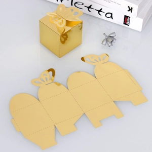 Macro detail of gold butterfly hollow favor box with flat cardstock template assembly