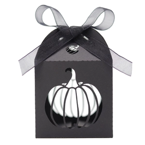 Detail of black Halloween candy box with laser-cut pumpkin design and ribbon bow
