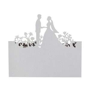 Detailed laser-cut wedding place card featuring a bride and groom silhouette design