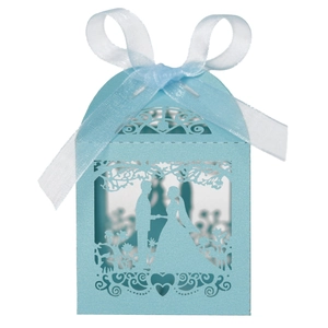 Detail of light blue laser-cut wedding favor box with bride and groom silhouette and ribbon