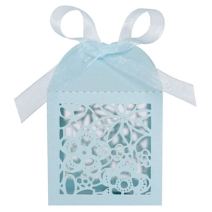 Close-up of light blue laser-cut wedding favor box with floral patterns and silk ribbon