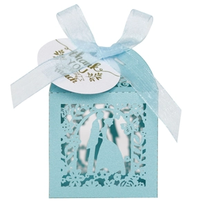 Detail view of light blue laser-cut wedding favor box with ribbon and thank you tag