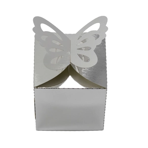 Macro shot of silver mirror candy box featuring laser-cut butterfly wings design