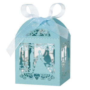 Detailed laser cut light blue favor box with bride and groom silhouette and white ribbon