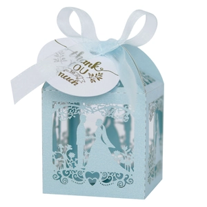 Close-up of light blue laser-cut wedding gift box with romantic silhouette and ribbon