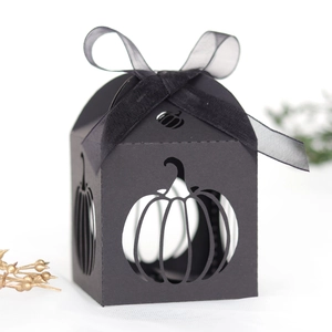 Detail of black laser-cut Halloween pumpkin candy box with a neat silk ribbon bow