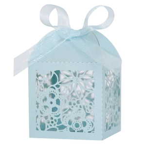 Detail view of light blue laser-cut wedding candy box with elegant floral hollow pattern
