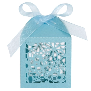 Detail of light blue laser-cut candy gift box with floral patterns and a matching ribbon bow