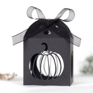 Detail of laser-cut pumpkin design on black gift box with a black organza ribbon bow