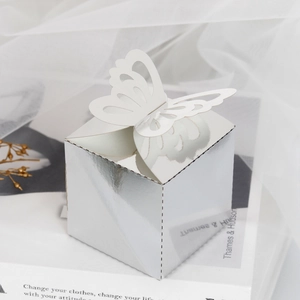 Close-up of silver mirror favor box with laser-cut butterfly on top for weddings