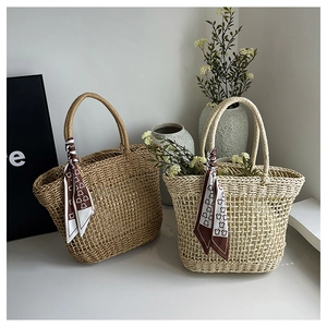 Detail of woven straw tote bags with bear print scarves for summer beach vacations