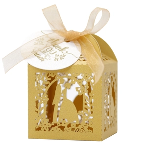 Detailed laser-cut gold wedding favor box with bride and groom silhouette and ribbon