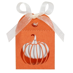 Detailed close-up of orange pumpkin laser-cut paper candy box with white ribbon bow