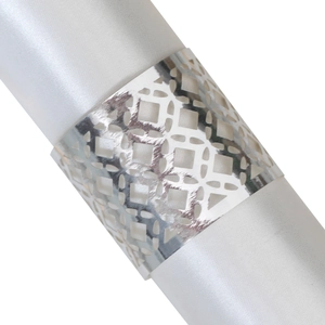 Elegant silver hollow geometric napkin ring wrapped on a white satin cloth decoration