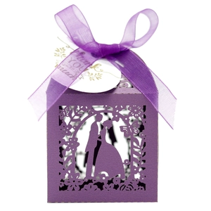 Detail of laser cut purple wedding candy box with elegant silhouette and silk ribbon