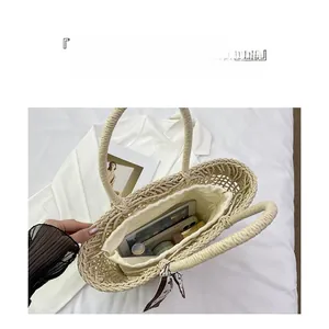 Interior view of straw tote bag showing large capacity for tablet and phone
