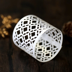 Detailed view of laser-cut white hollow pattern on decorative LED candle paper shade