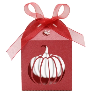 Detail of red Halloween pumpkin laser-cut paper gift box with elegant silk ribbon bow