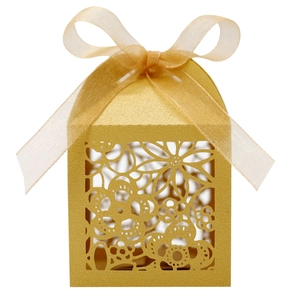 Detailed laser-cut gold floral favor box with pearlescent finish and elegant ribbon