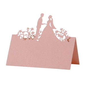 Pink pearlescent laser-cut wedding table card featuring romantic bride and groom silhouette