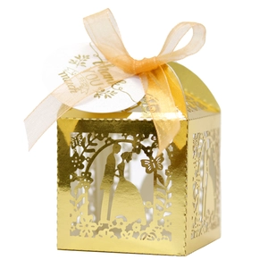 Golden laser-cut wedding favor box with ribbon and Thank You tag on white background
