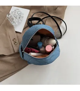 Interior view showing the spacious storage capacity of a blue quilted denim mini backpack