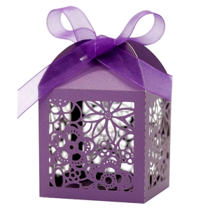 Elegant purple laser-cut wedding favor box with floral patterns and a ribbon bow