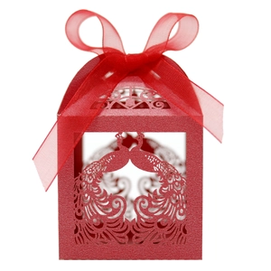 Detailed laser-cut red wedding favor box with peacock pattern and silk ribbon bow