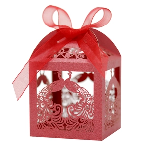 Detail of red laser-cut peacock candy box with elegant ribbon and pearlescent finish