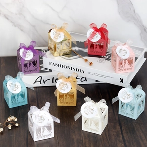 Detailed laser-cut wedding favors with silk ribbons and thank you tags in various colors