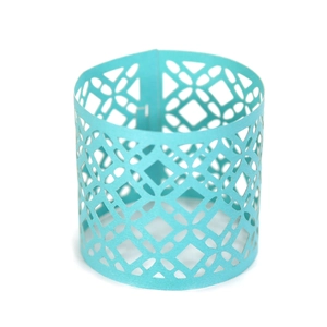 Detail of light blue laser-cut cupcake wrappers with intricate geometric patterns