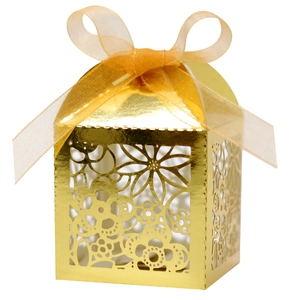 Elegant gold laser-cut candy box with floral patterns and a sheer ribbon bow