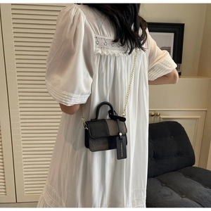 French style crossbody bag shown on white lace dress highlighting its texture