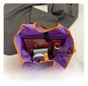 Detail view of purple nylon tote bag spacious interior with pockets and daily essentials