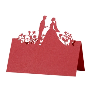 Elegant red laser-cut wedding place card featuring a bride and groom silhouette design