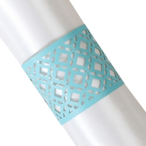 Light blue laser-cut hollow napkin ring with geometric lace pattern on white satin