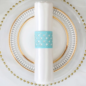 Sky blue laser cut napkin ring with geometric hollow pattern on a white napkin