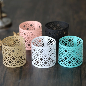 Laser-cut geometric paper napkin rings in five metallic colors for festive table decor