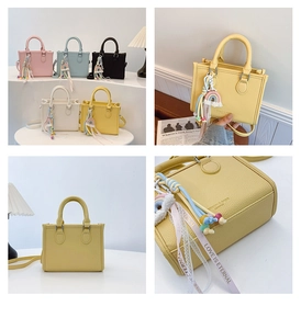 Macro shot showing lychee texture leather handbag with colorful woven charm and ribbon