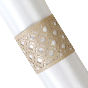 Close-up of golden laser-cut hollow napkin ring featuring a geometric diamond pattern