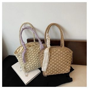 Detail of hand-woven straw bucket bags with pearl silk scarf and inner drawstring pouch