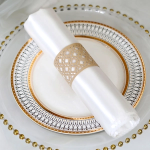 Close-up of golden hollowed-out paper napkin ring with laser-cut geometric pattern