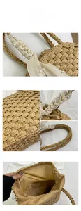 Detail of straw handbag with woven texture, pearl handle and drawstring lining